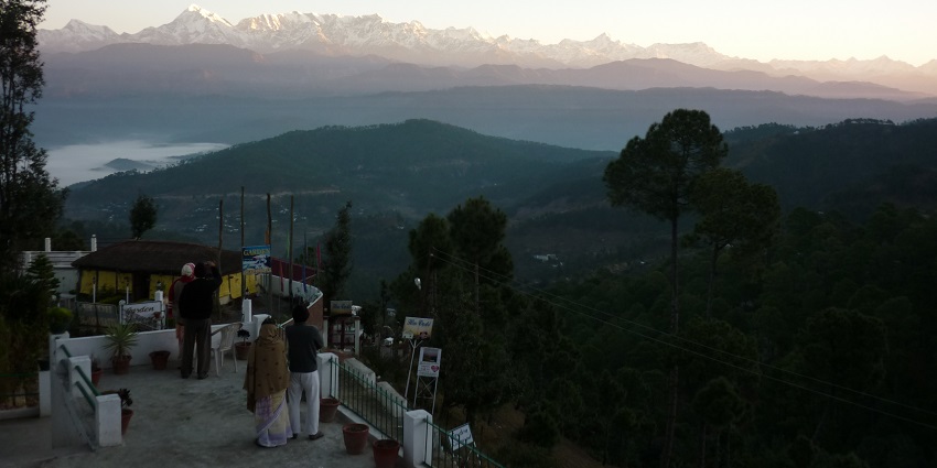 Scenic trekking route leading to a historic hilltop temple, pictured in evening.