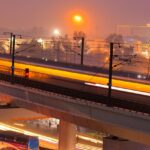 An image of the night of a moving train on tracks during dusk in Bareilly.