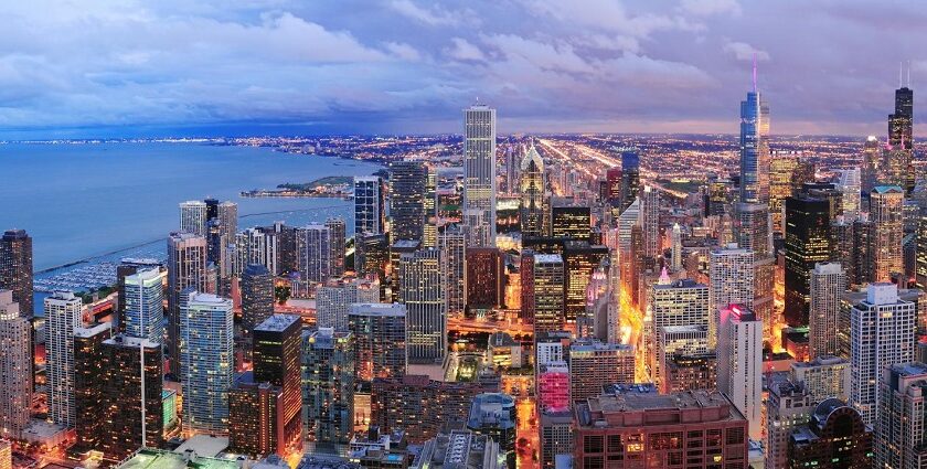 Chicago's skyscrapers and corporate headquarters with roads well-lit in the evening