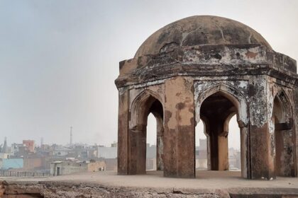 A picture of a dome of a historical mosque in Panipat with views of the city in the background