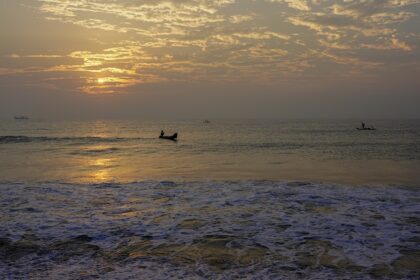 An image showing a scenic view from University Beach in Pondicherry, showcasing calm waves and sand.