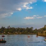 A panoramic view of a serene lake in Salem showcasing urban structures and greenery.