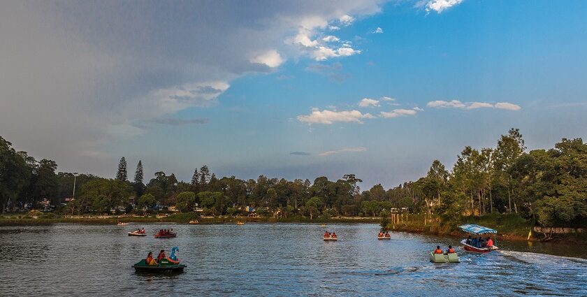 A panoramic view of a serene lake in Salem showcasing urban structures and greenery.