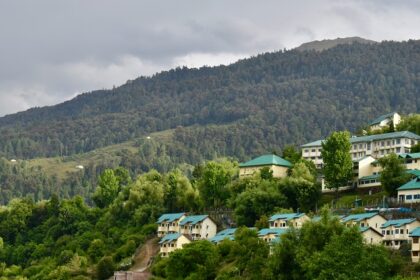 Places to visit in Uttarakhand in July offer a temple surrounded by mountains