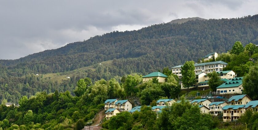 Places to visit in Uttarakhand in July offer a temple surrounded by mountains