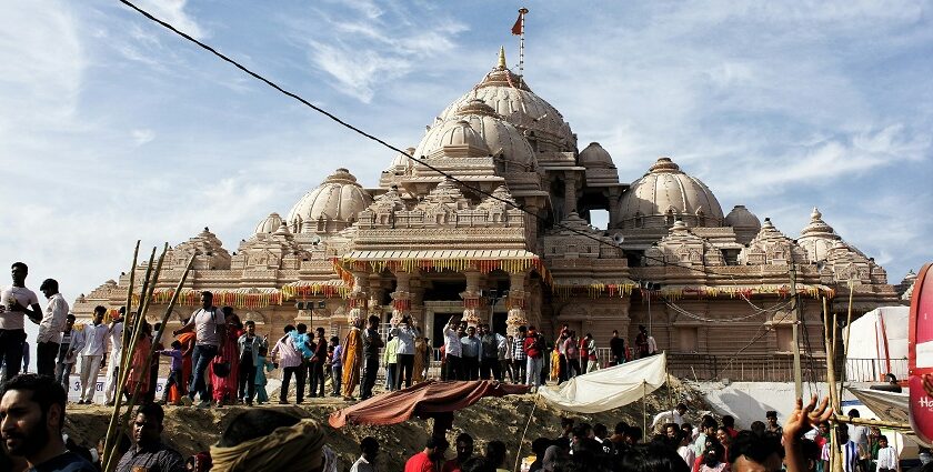 A picture of a temple in Rohtak with a crowd of devotees standing in queue outside