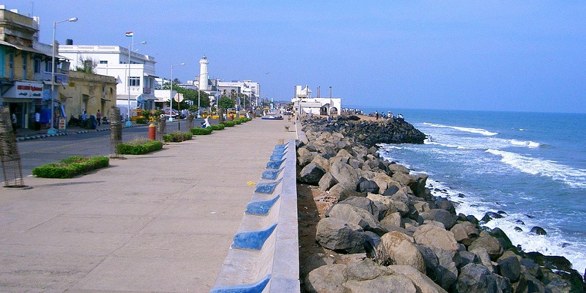 Puducherry beach with soft sand, gentle waves, and palm trees lining the shore is one of the places to visit in Tamil Nadu with family