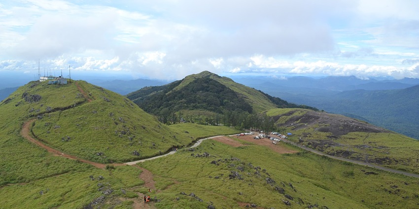 An awe-inspiring view of Ponmudi featuring lush green valleys and dense forests.