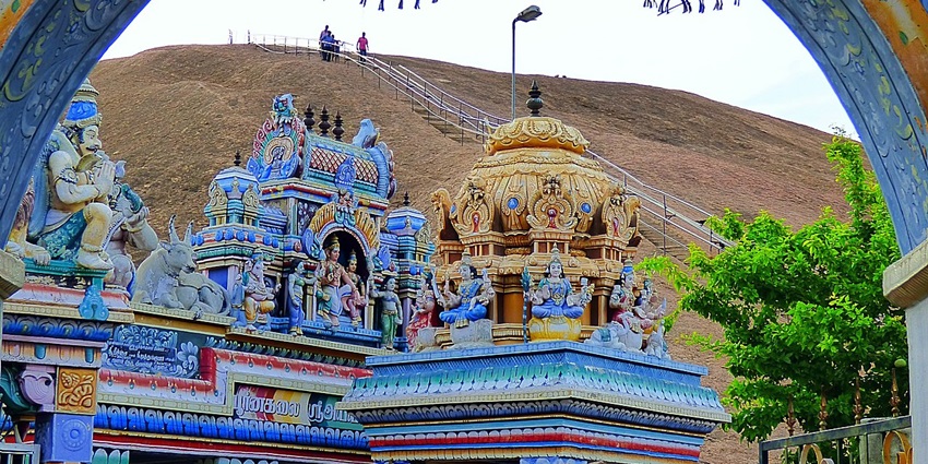 Ayyanar temple with Samanar hills in the background and people walking from down the hill.