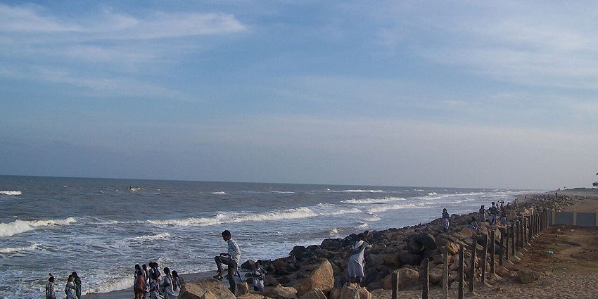 Golden sands stretch from Kaveri river mouth, with ancient port city ruins and poetic coastal views, situated near Kethu temple.