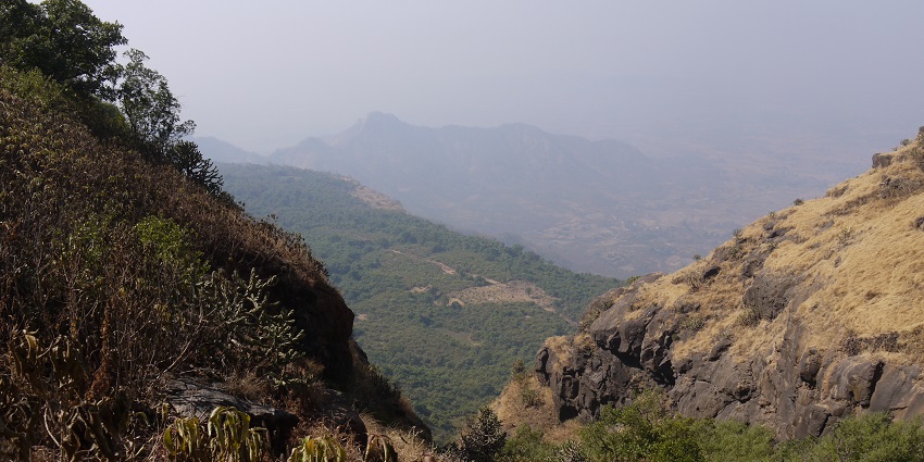A scenic picture from the top of Parbalmachi, featuring lush green mountains