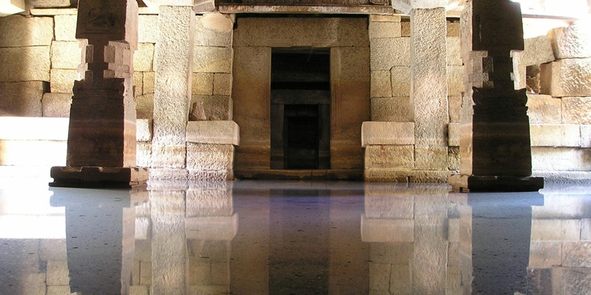 An image showing a grayscale view of a temple hallway, capturing architectural depth.