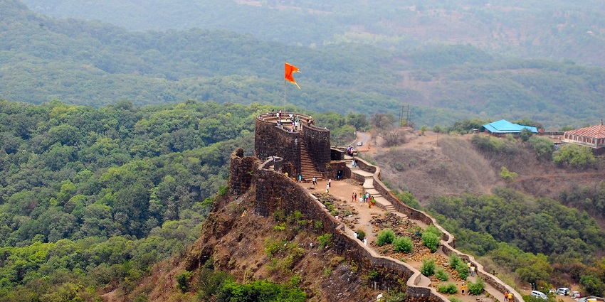 A picture of Pratapgad Fort with its imposing walls and forested surroundings.
