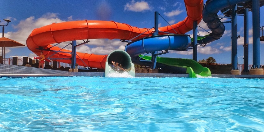 An image of a waterslide spiralling down into a pool at Prem Wonderland and Water Kingdom.