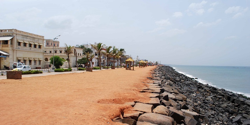 A view of Promenade Beach in Pondicherry with street lights illuminating the path.