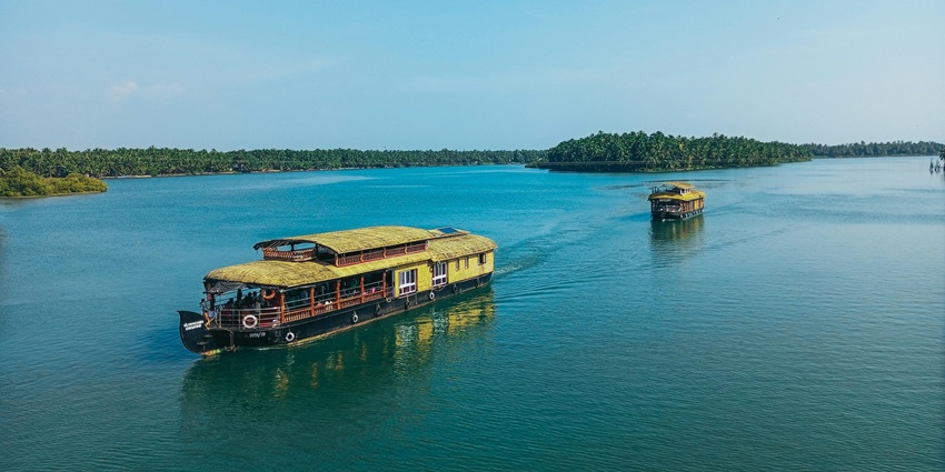 A panoramic view of two big boats sailing through the water on the Punganoor Lake.