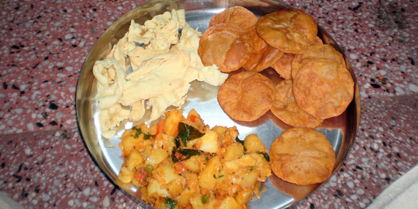 A plate of Puri Sabzi, one of the famous food in Vrindavan for an authentic taste.