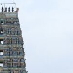 Visitor area of Putlur temple with grand architecture of the temple structure in view.