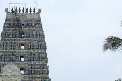 Visitor area of Putlur temple with grand architecture of the temple structure in view.