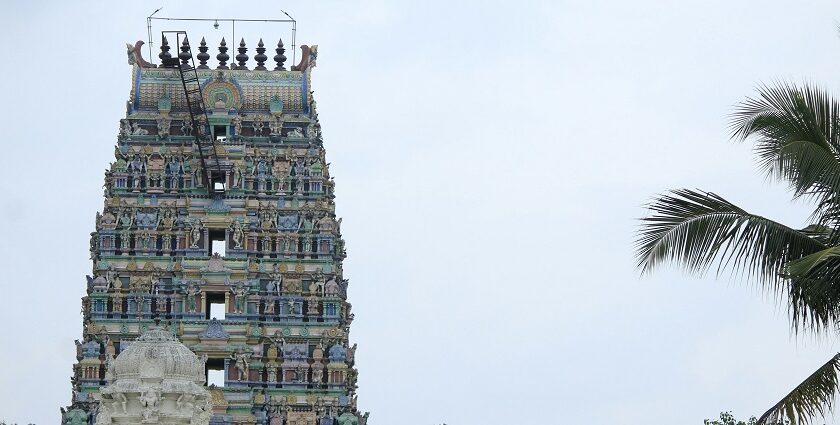 Visitor area of Putlur temple with grand architecture of the temple structure in view.