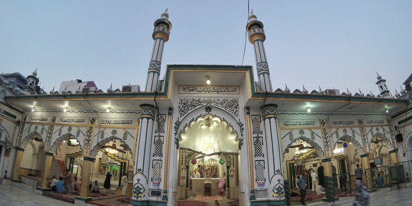 View of Dargah Hazrat Abbas with intricate architecture and vibrant surroundings.