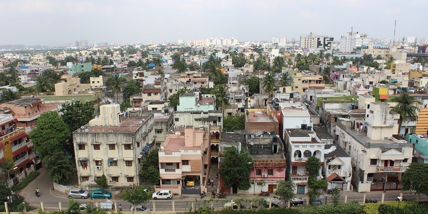 Residential area near Vadapalani Temple with apartment buildings and parked vehicles.