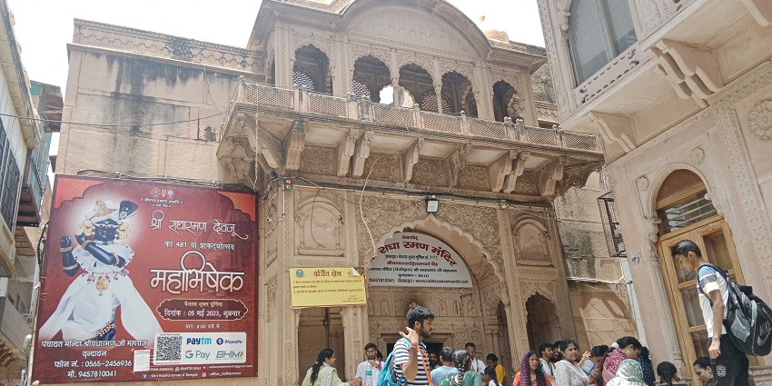 Ancient Radha Raman Temple with carved pillars, stone steps, and arched doorway in Vrindavan