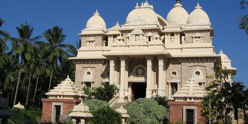 A photo of the Ramakrishna Mutt featuring traditional architecture, dense gardens.