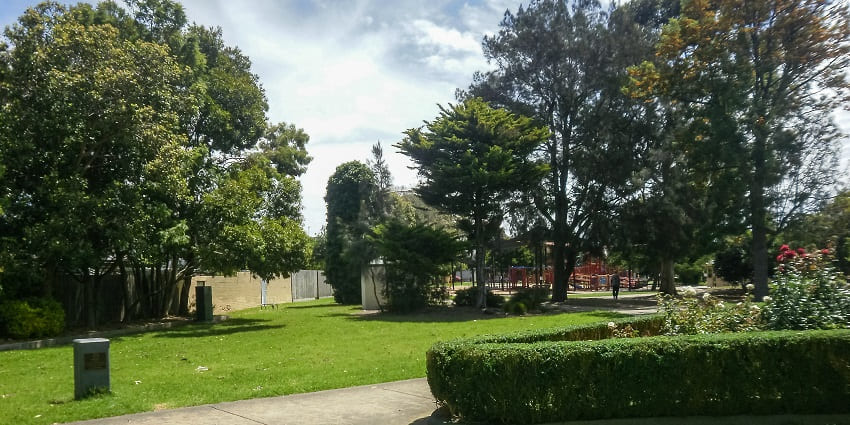 Serene view of the park with lush green surroundings.