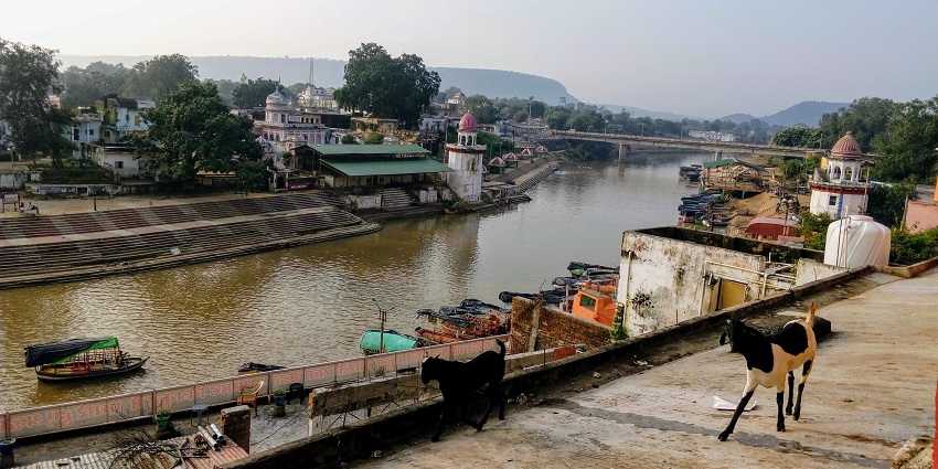 Pilgrims and boats along the sacred Ramghat on the Mandakini River in Chitrakoot.