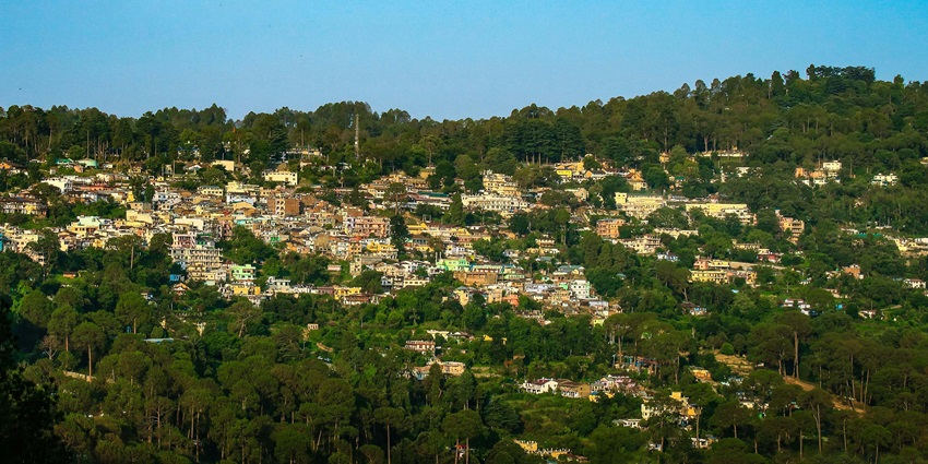 A panoramic view of the scenic Ranikhet region of Almora, with an abundance of trees and greenery