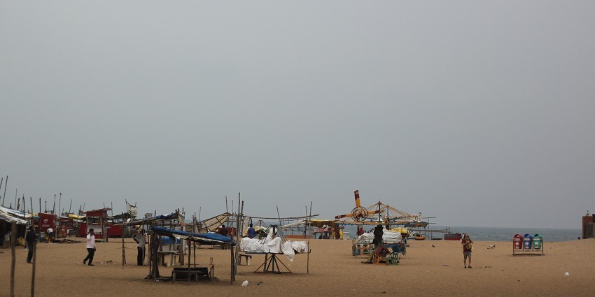 A beach Capri at Besant Nagar Beach, showcasing a small food stall with colourful umbrellas