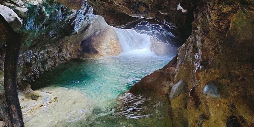 Robber's Cave near Subir Raha Oil Museum features unique rock formations.