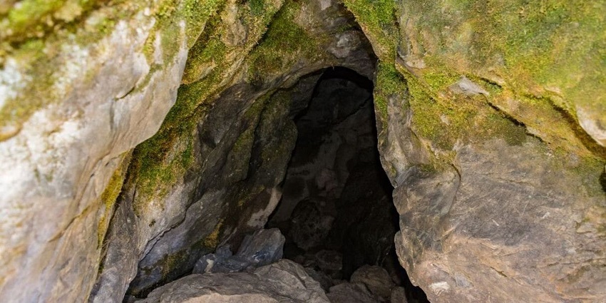 Things to do in Kausani inlcude visiting waterfall and caves surrounded by lush green hills.
