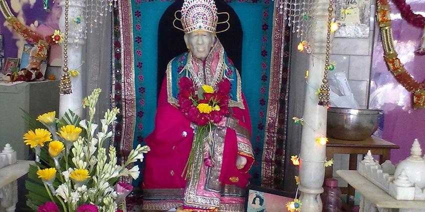 An image showing the statue of Sai Baba adorned with garland in an important Sai Baba temple in Chennai.