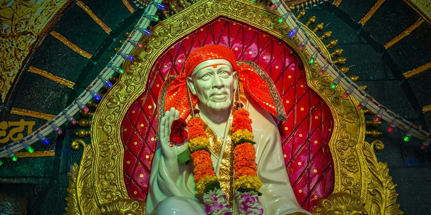 A divine view of the idol of Lord Sai Baba in a temple in Mussoorie with a lot of pilgrims.