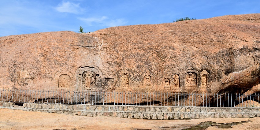 Ancient Jain carvings on rock surfaces at Samanar Hills, showcasing detailed sculptures