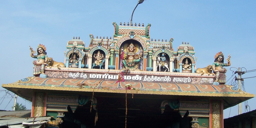 The entrance of Samayapuram Mariyamman Temple with vibrant sculptures and designs.