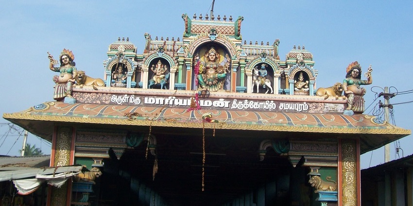 A picture of devotees offering prayers at the Samayapuram Mariamman Temple.