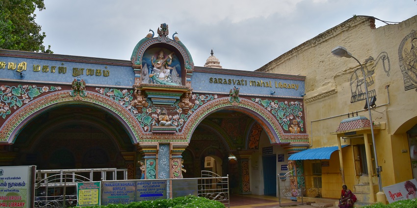 Outside the Saraswati Mahal Library with its carved colourful structure next to a building.