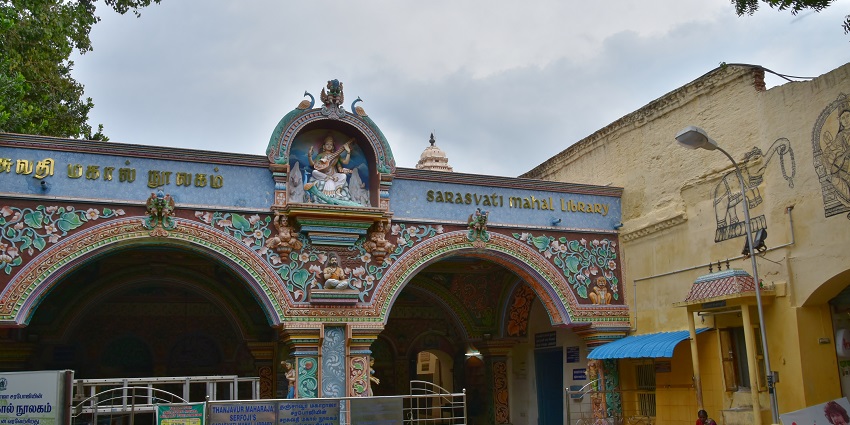 Outside of Sarasvati Mahal Library with arched gates, detailed stonework and a courtyard.