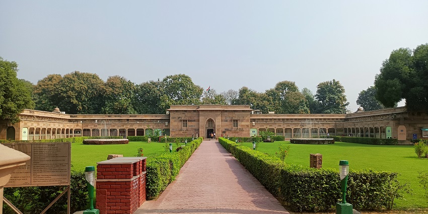 A frontal view of the Sarnarth museum taken from a distance, with a walkway leading to the main entrance