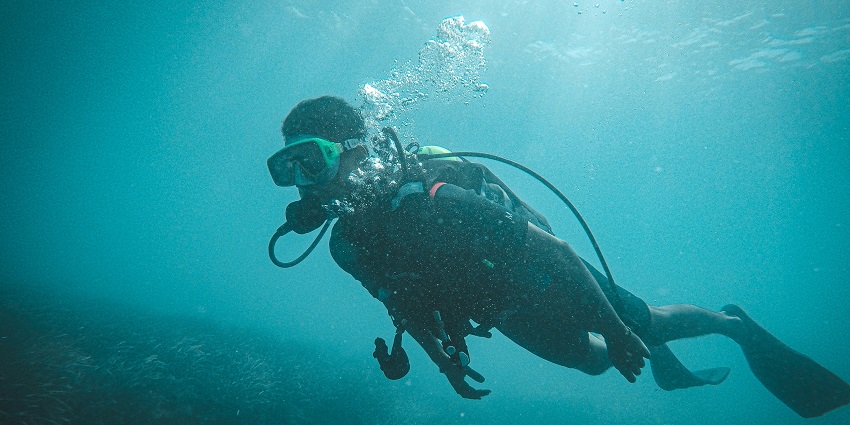 Image of a man scuba diving, one of the best activities at Holy Island water sports