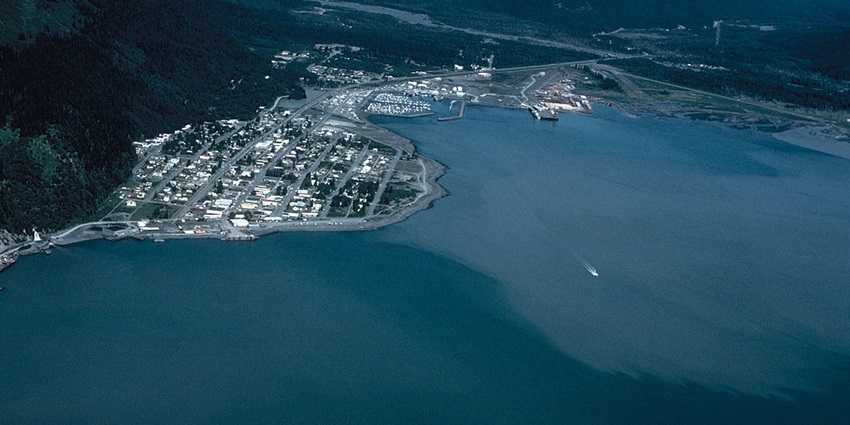 An aerial view Seaward showing huge mountain ranges, houses and a lake surrounding it.