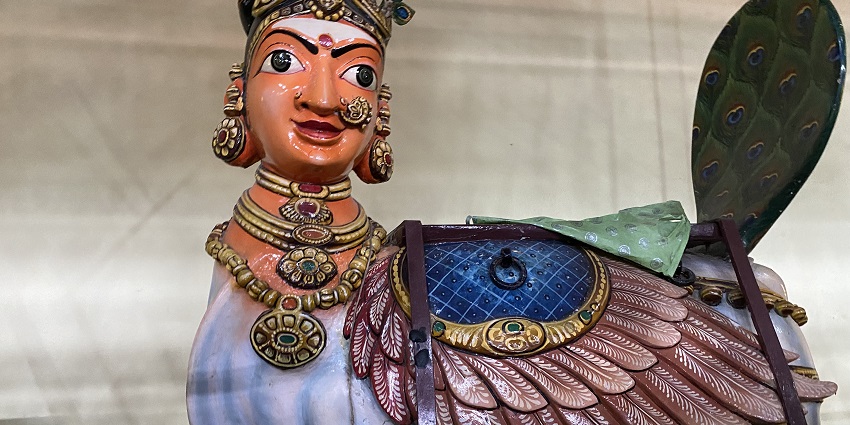 A colourful statue of the goddess as half-human and half-peacock in Mayiladuthurai Temple.
