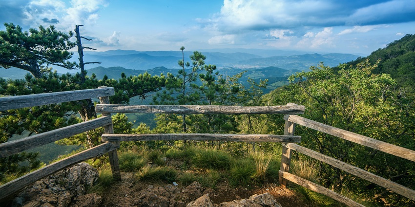 View of the clouds passing by from a viewpoint of a mountain top.