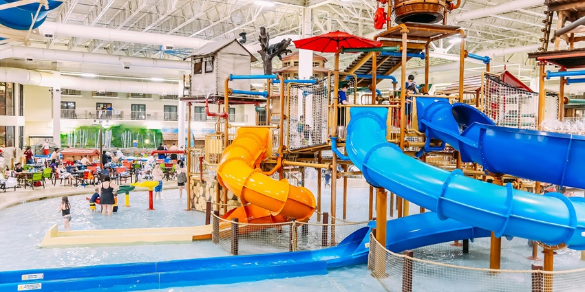 An enchanting view of an indoor waterpark with amazing slides during the daytime.
