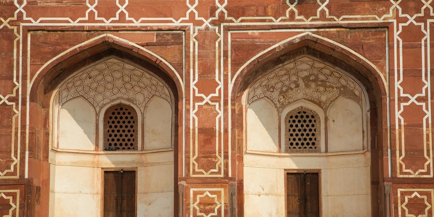 Facade of a brown and white concrete building, a popular tourist attraction near Nilansh Water Park.