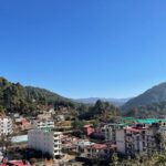 A picture of the scenic landscape in Uttarakhand, with greenery and mountains