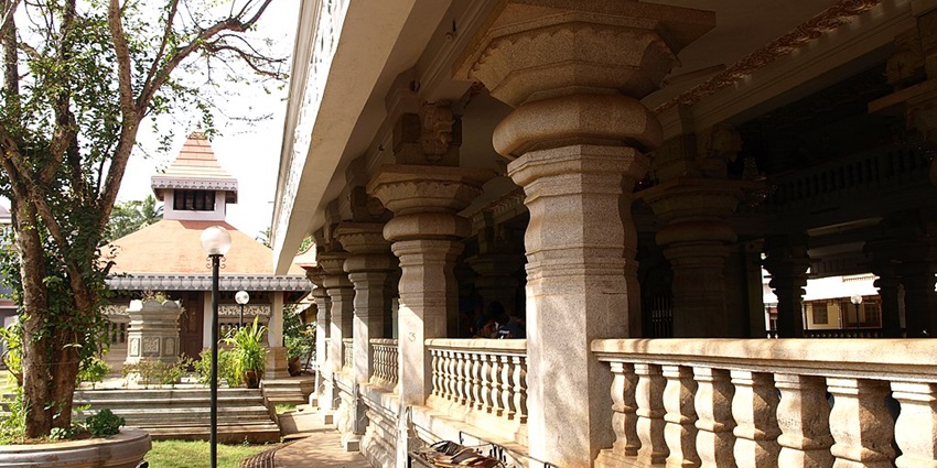 Shri Nagueshi Temple with its pillars and scenic backyard.